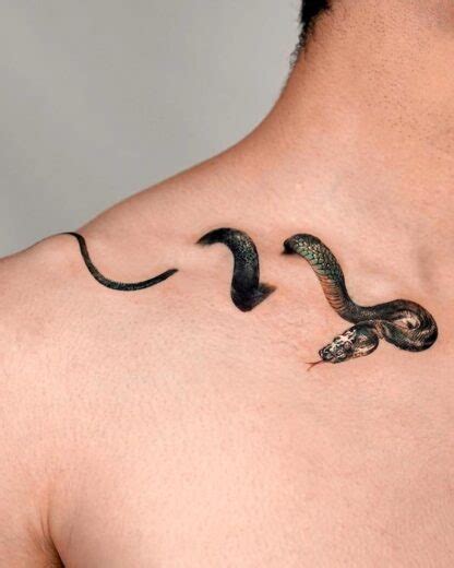 snake tattoo between breast|snake tattoo on back female.